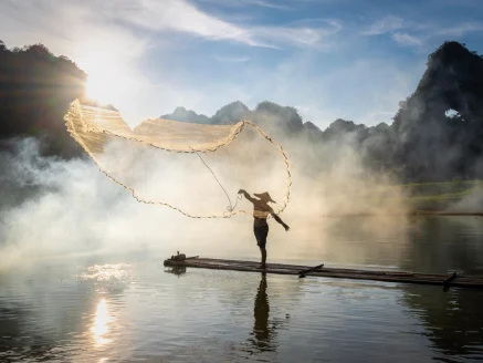 Person balancing on water at sunrise representing emotional healing and mindfulness